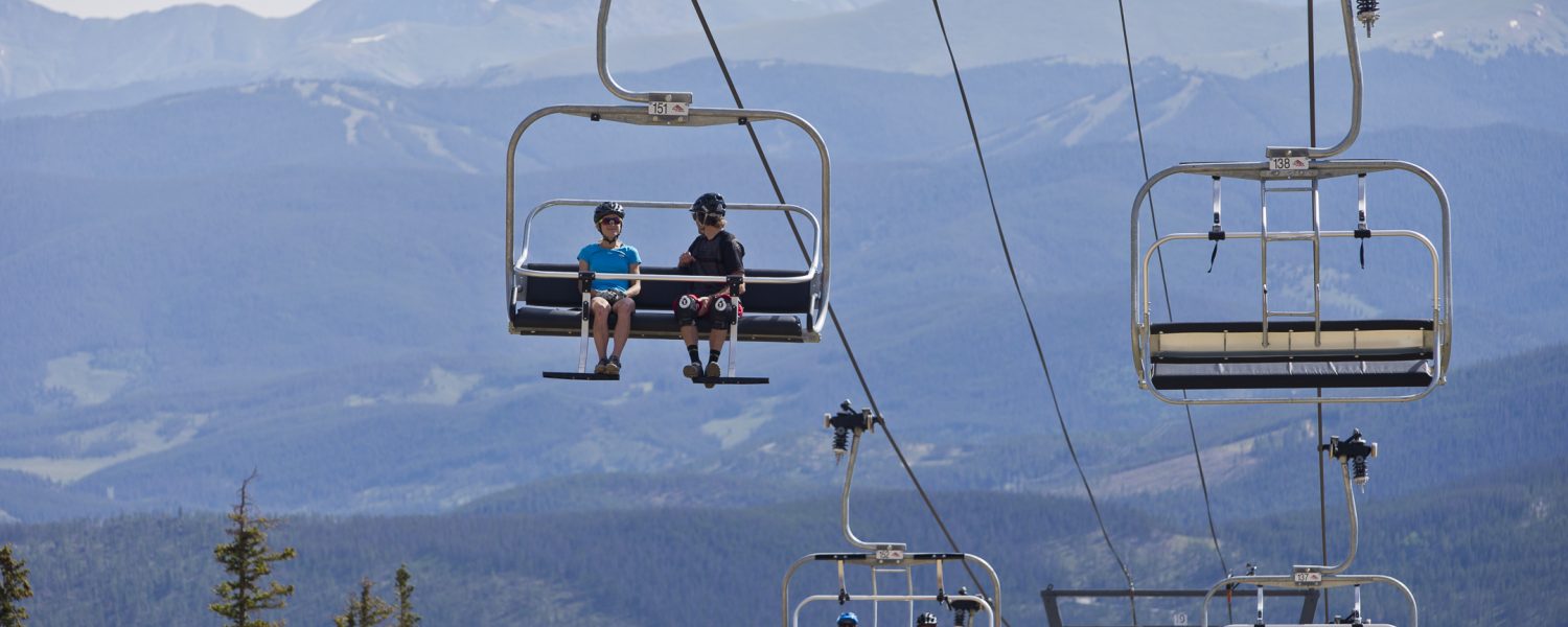 A group of friends taking the chairlift to bike on Peak 8 in Bre