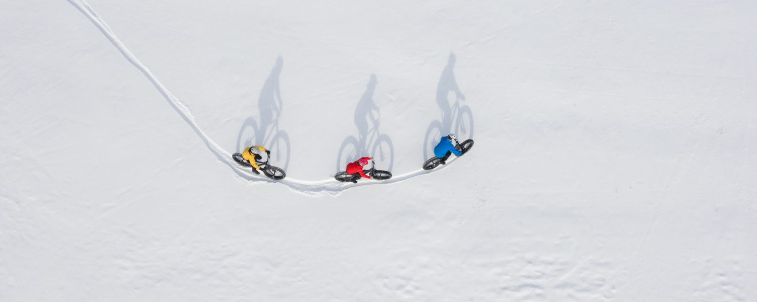 Aerial drone photo of a group of friends riding their fat bike in the snow in Ontario, Canada
